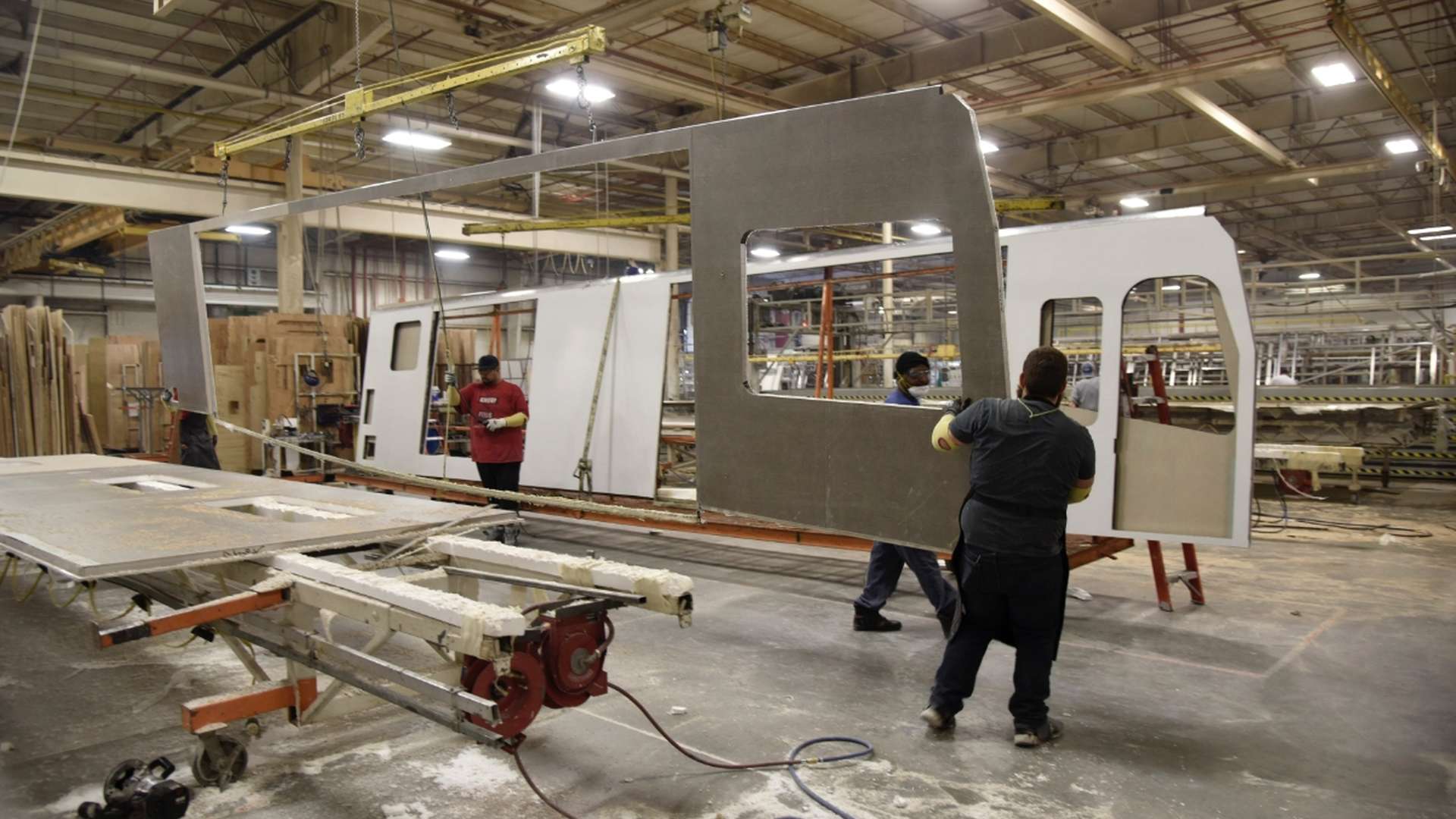 People constructing a vehicle